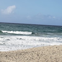 a man is riding a surfboard on a beach