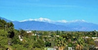 a view of the mountains with trees in the background